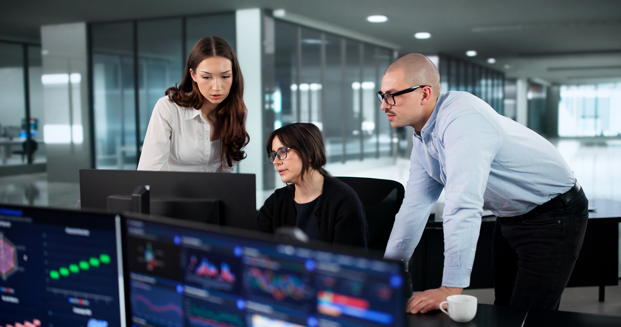 Financial crime analysts reviewing real-time monitoring dashboards